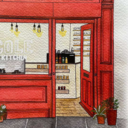 Illustration of a red door leading into a coffee shop interior.