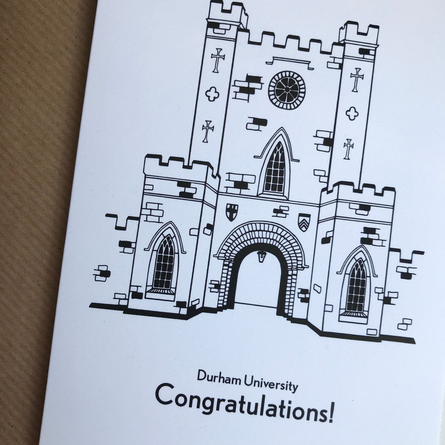 Greeting card with a Durham university illustration and 'Congratulations!' text on a brown background