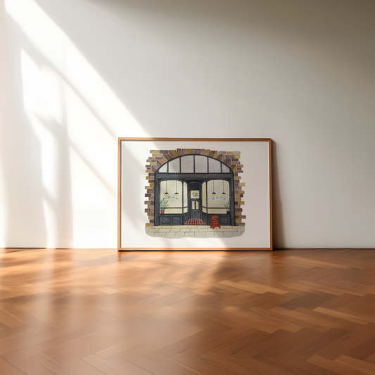 Framed artwork of Axis Bar, Gateshead on a wall in a room with wooden flooring