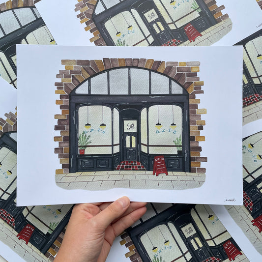 Art print of Axis Bar, Gateshead held by a hand on a patterned surface