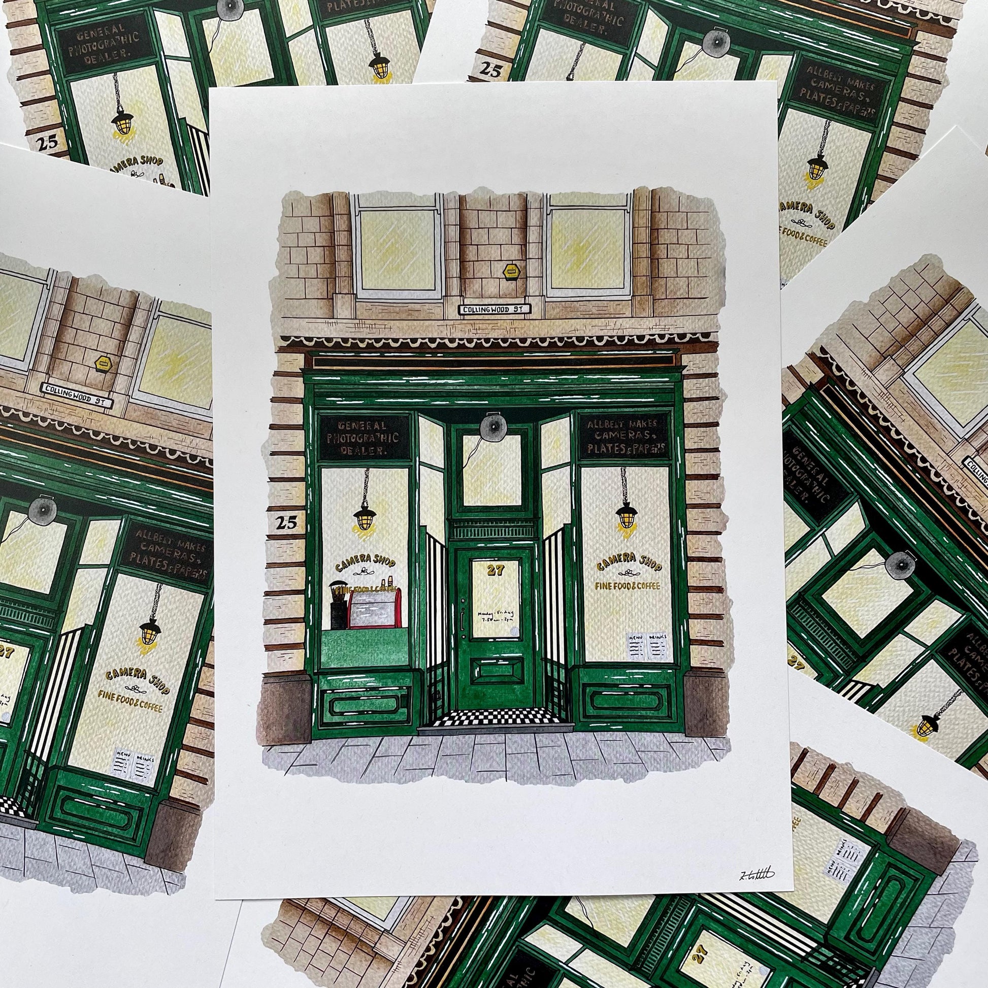 Illustration of Camera Shop sandwich shop with green doors and signage.