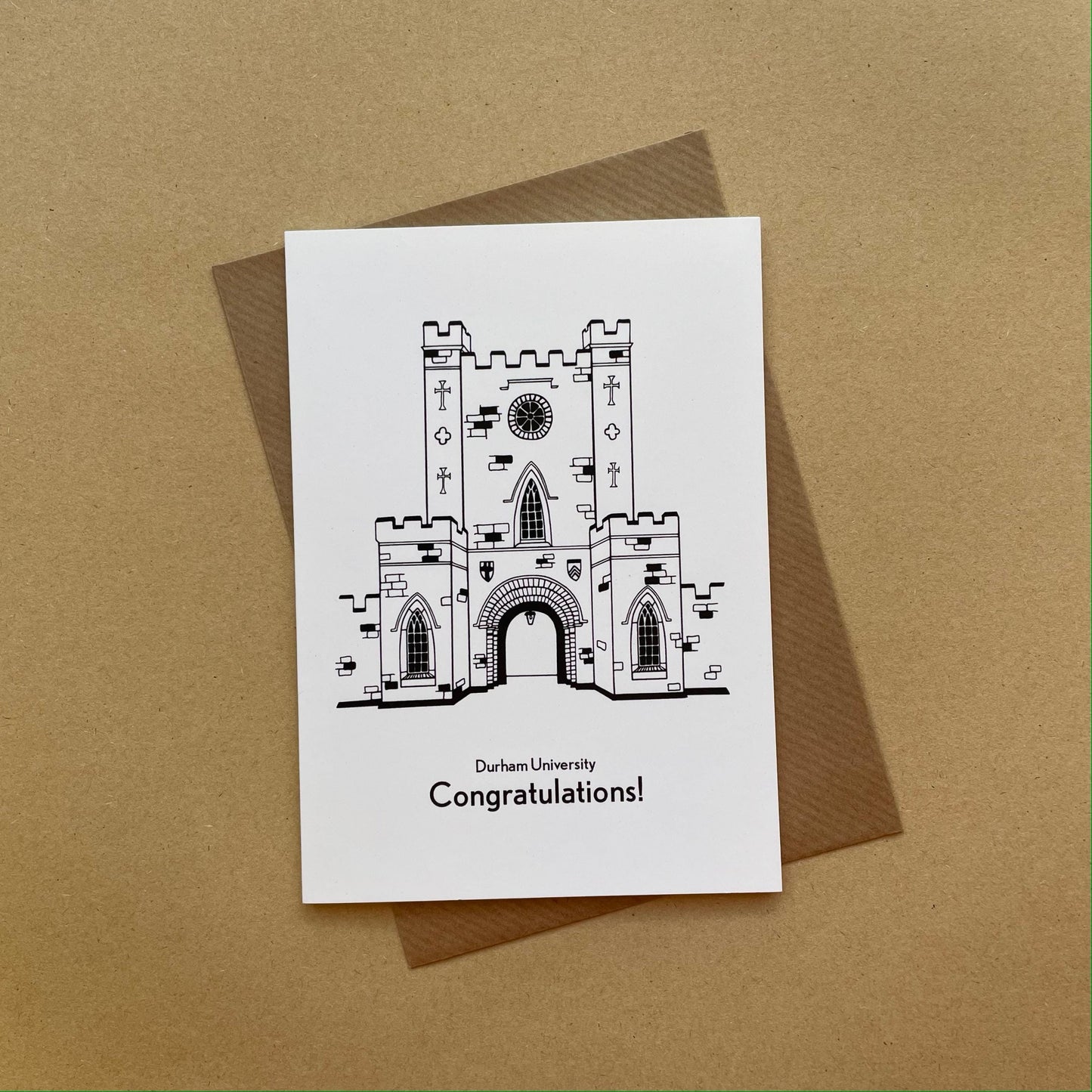 Greeting card with a Durham university illustration and 'Congratulations!' text on a brown background