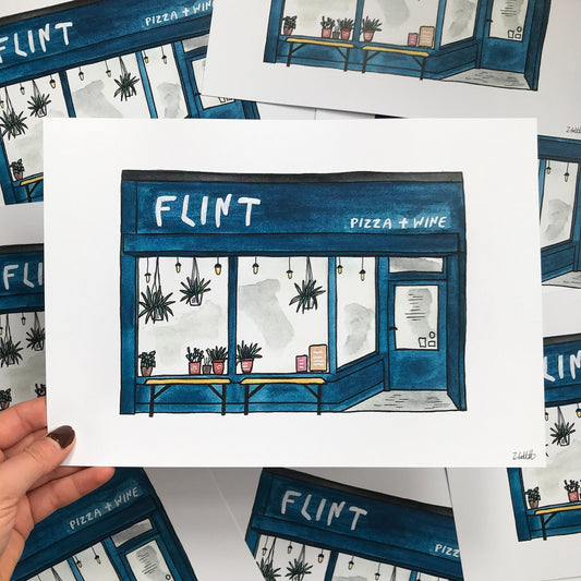 Illustration of a pizza and wine shop named 'Flint' held by a hand.