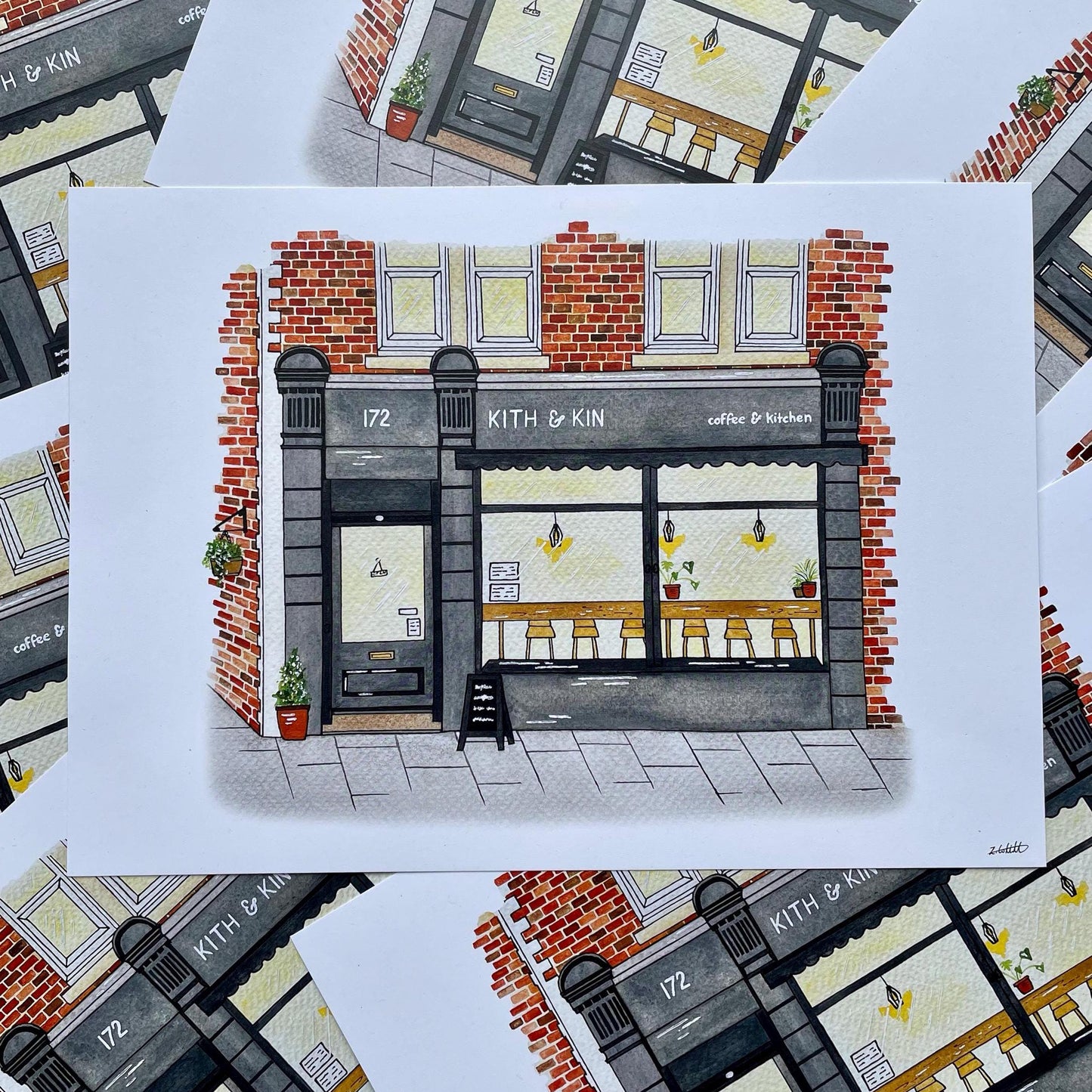 Illustration of a coffee shop named 'Kith & Kin' on a white card with a patterned background.