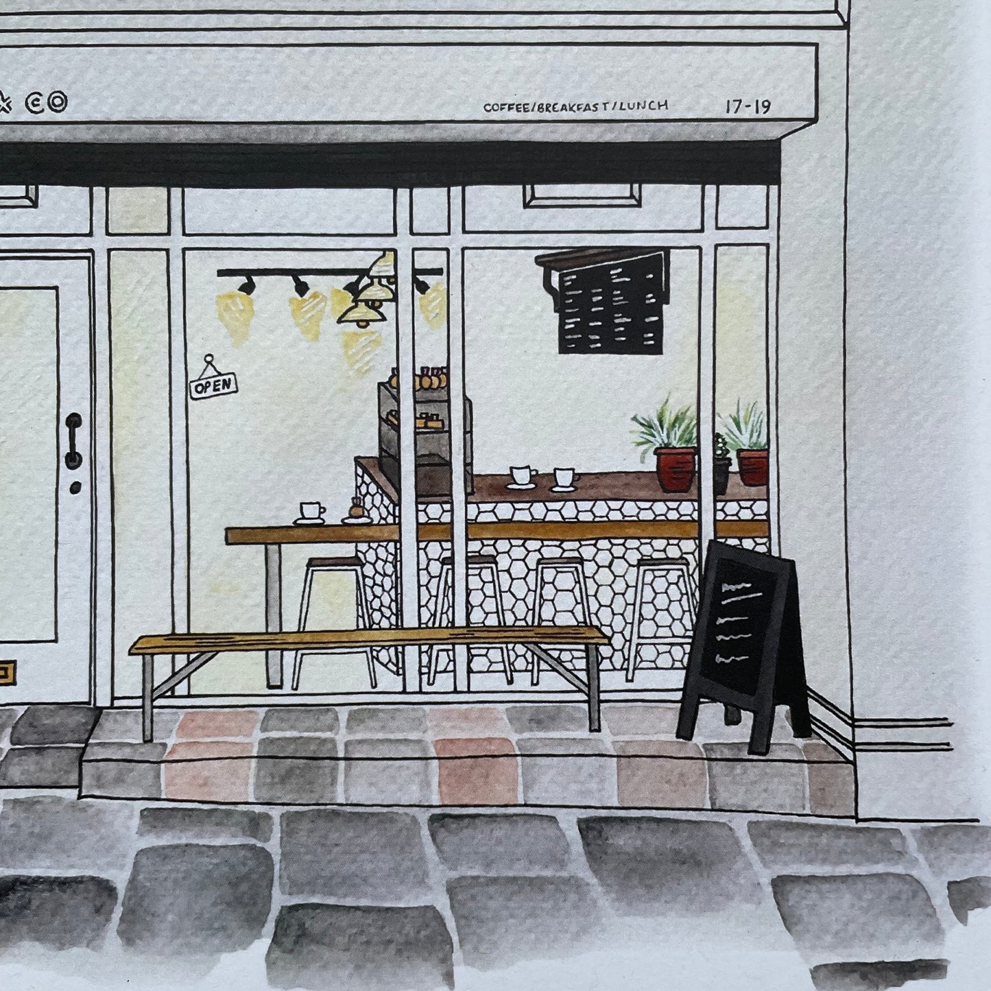 Illustration of cafe Laneway & Co newcastle with a sign outside and view of the interior cafe.