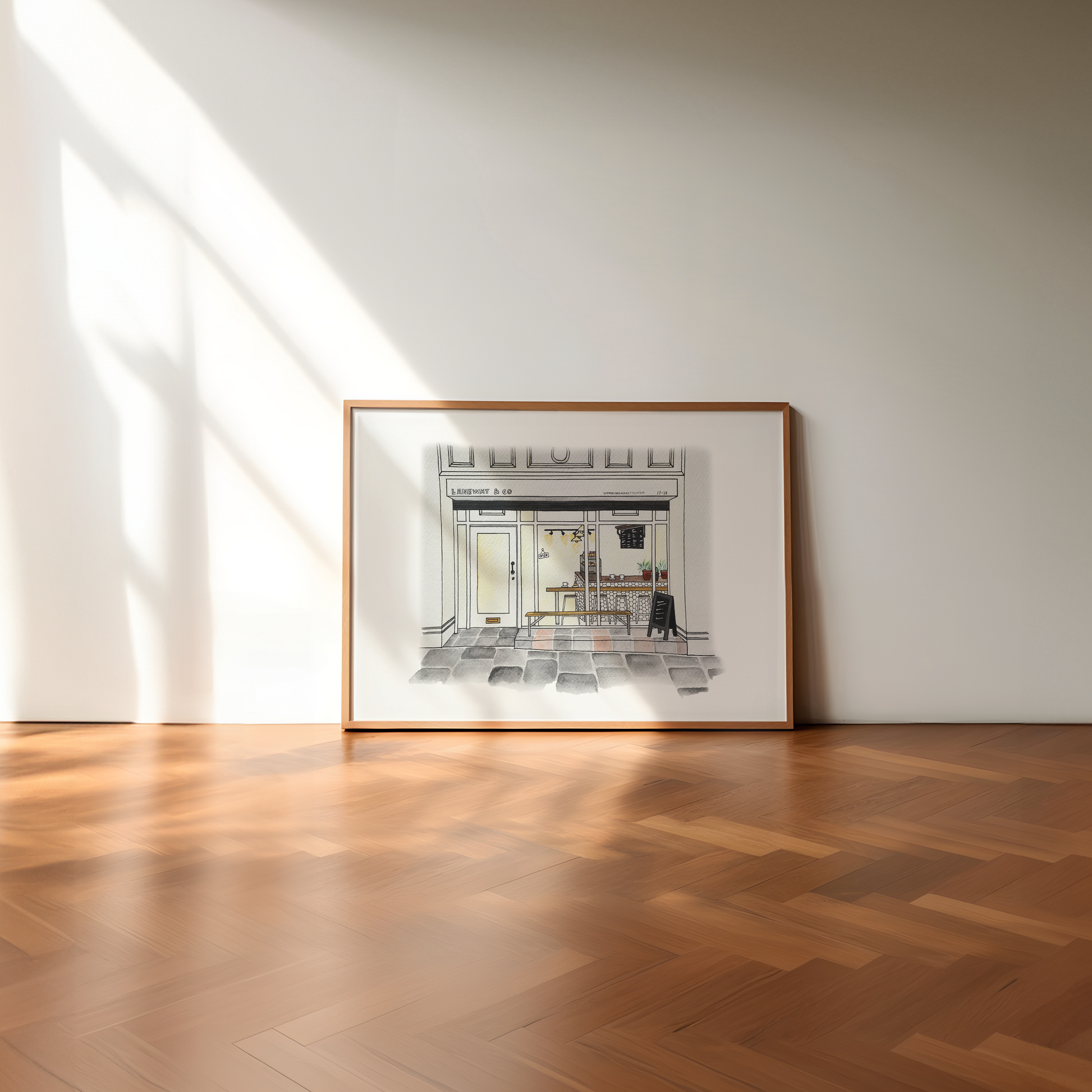 Framed artwork of Laneway Coffee newcastle Upon Tyne on a wall in a room with wooden flooring