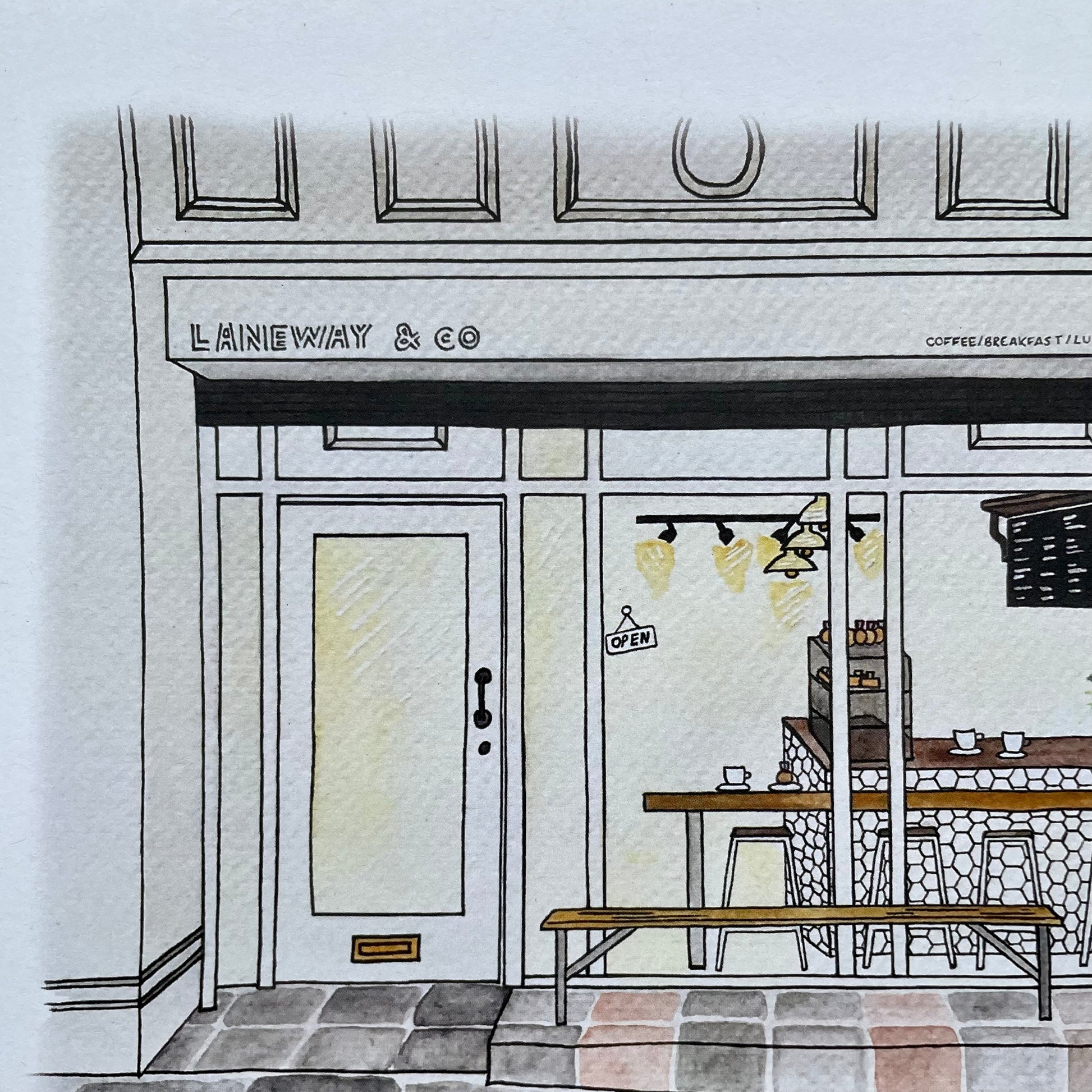 Illustration of a coffee shop named 'LANEWAY & CO' with a door and interior.