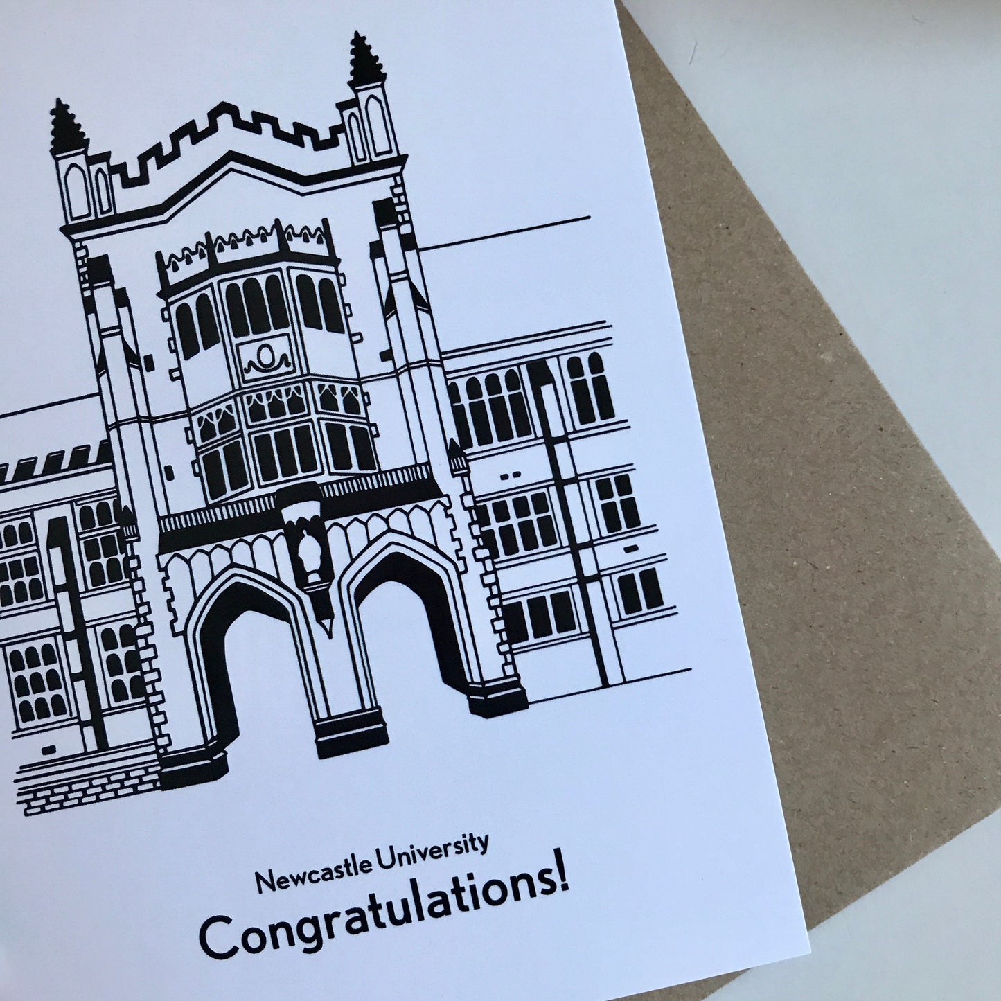Greeting card with Newcastle University building illustration and 'Congratulations!' text on a white background.