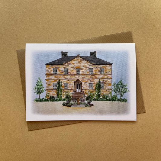 Greeting card with an illustration of Newton Hall wedding venue illustration displayed on a brown background