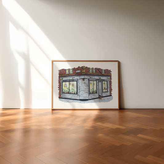 Framed artwork of Aidans Kitchen, Sandyford on a wall in a room with wooden flooring