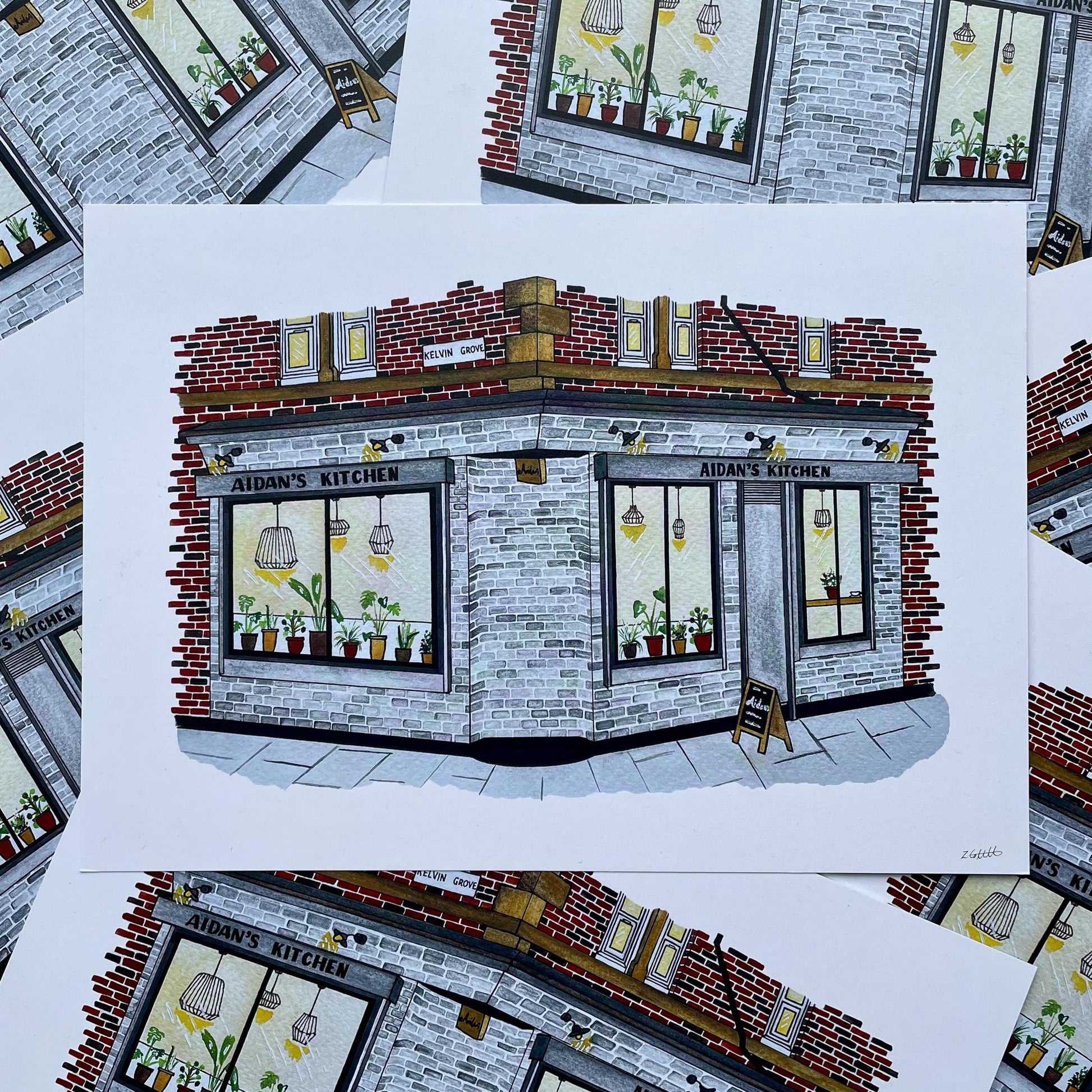 Illustration of a cafe named 'Aidans Kitchen' on a white background with a brick and stone facade.