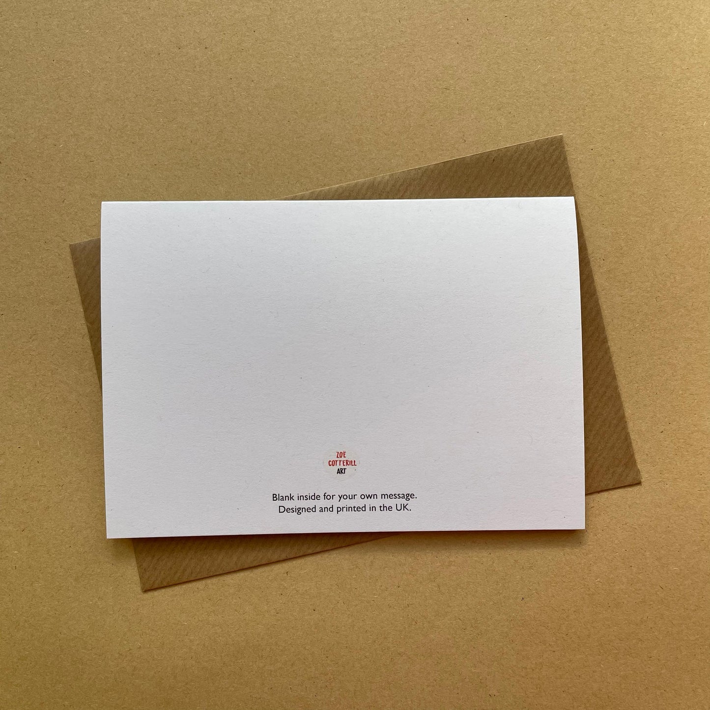White card with red text on a brown envelope against a brown background