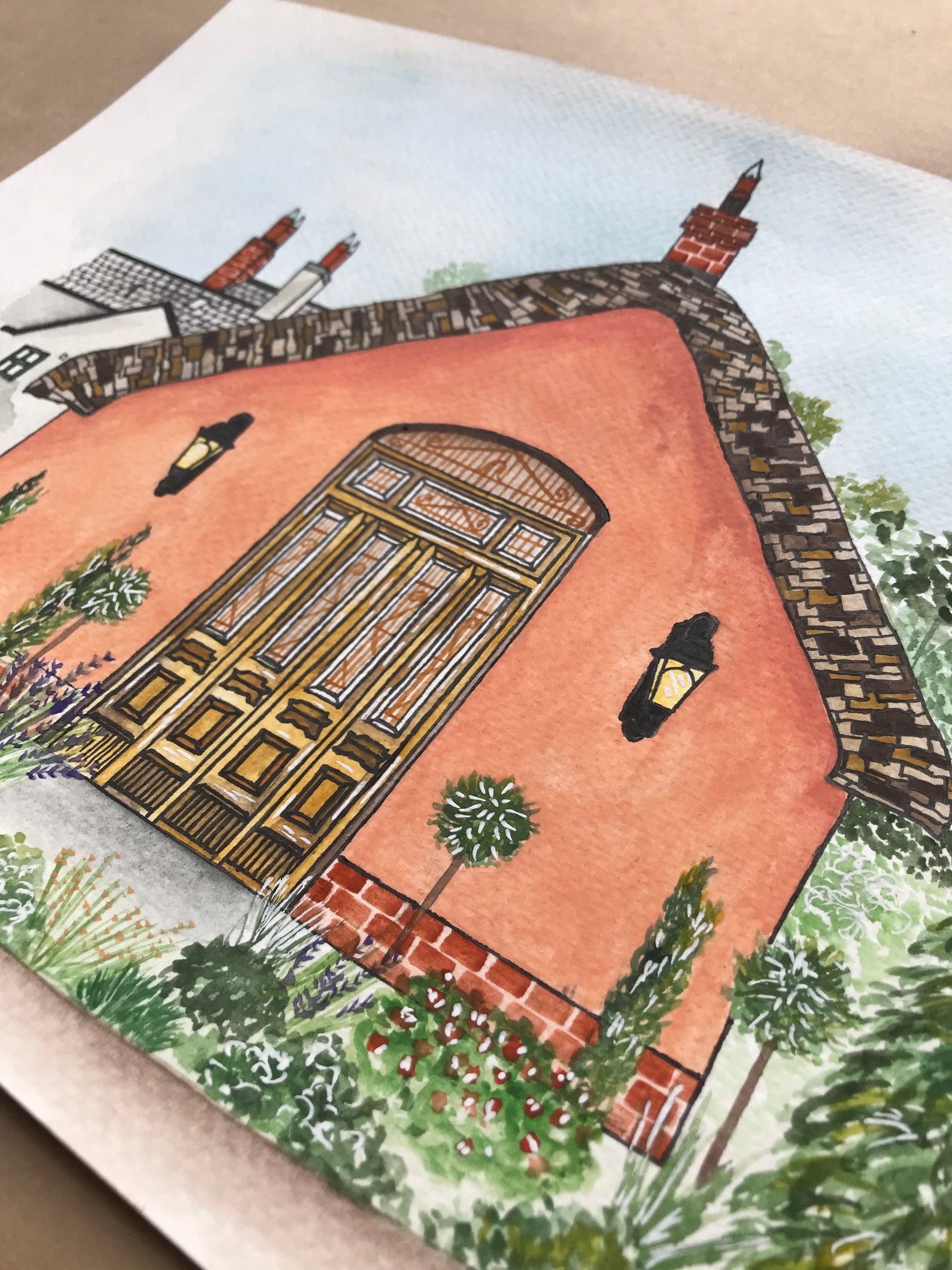 Illustration of a le Petit Château wedding venue with a garden on a postcard