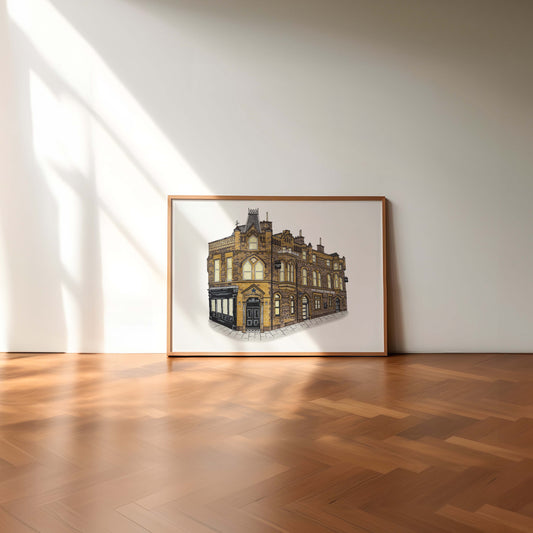Framed artwork of the punch bowl hotel newcastle on a white wall in a room with wooden flooring.
